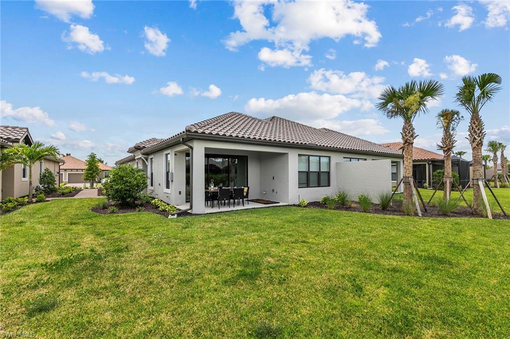 15189 Sacile Court Naples, FL 34114 - Photo 27 of 30 a view of a house with a yard