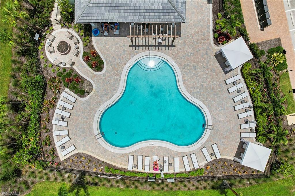 15189 Sacile Court Naples, FL 34114 - Photo 30 of 30 an aerial view of a swimming pool with outdoor seating and yard
