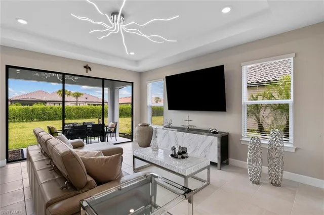 a living room with furniture a flat screen tv and a large window