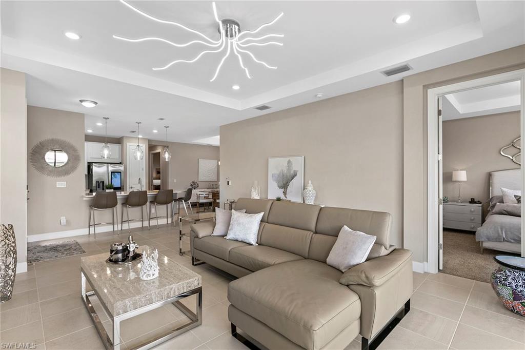 15189 Sacile Court Naples, FL 34114 - Photo 6 of 30 a living room with furniture and a large mirror