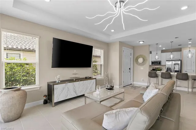 a kitchen with a dining table chairs stainless steel appliances and cabinets