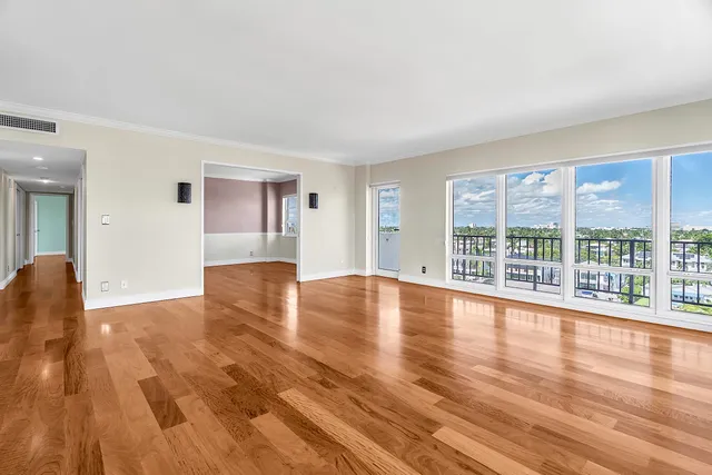 an aerial view of a city with lots of residential buildings ocean and mountain view in back