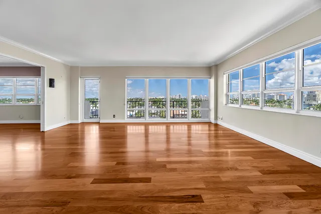 an aerial view of a city with lots of residential buildings ocean and mountain view in back