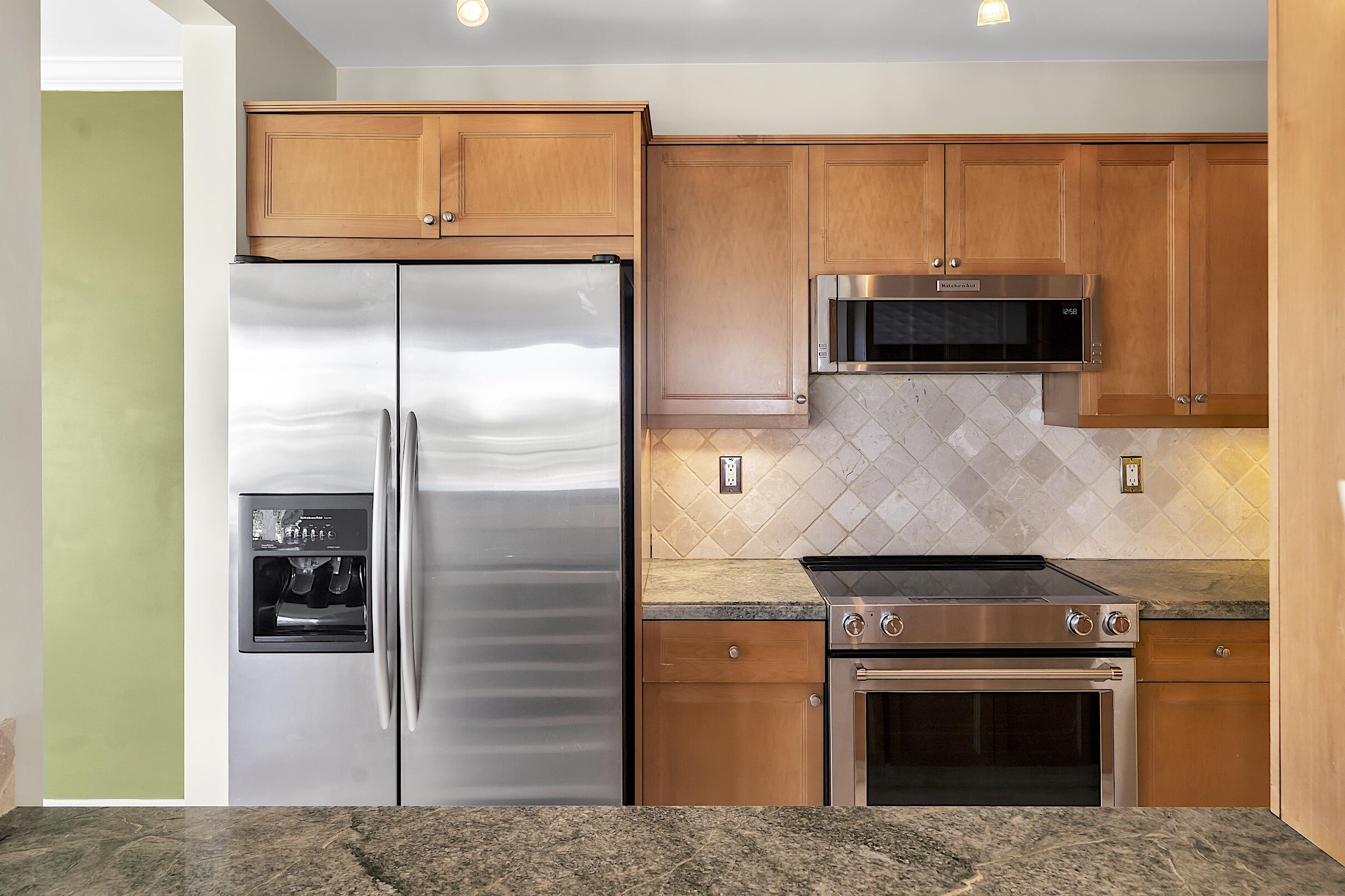 2500 East Las Olas Boulevard, Unit 802 Fort Lauderdale, FL 33301 - Photo 29 of 67 a kitchen with stainless steel appliances granite countertop a refrigerator and a stove top oven