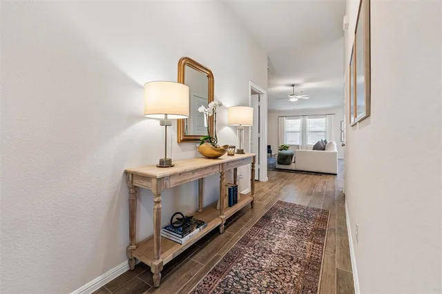 a view of living room with furniture and a lamp