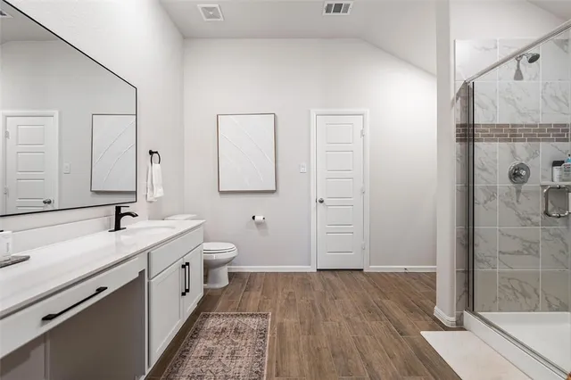 a bathroom with a double vanity sink a mirror and shower
