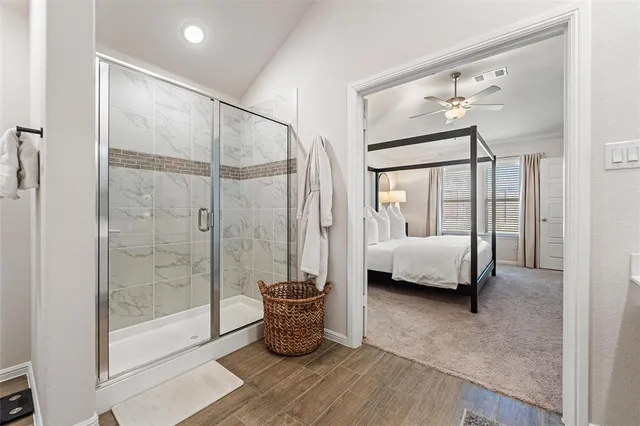 a en suite bathroom with a tub shower and window
