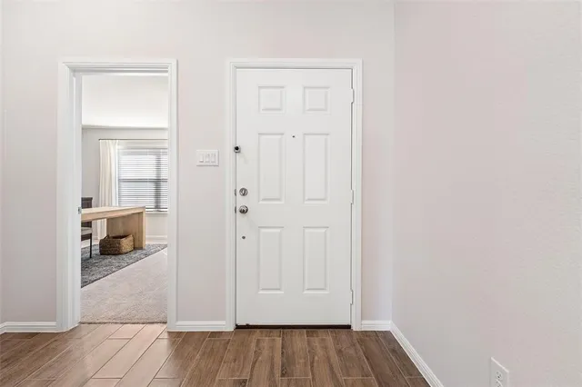 an empty room with wooden floor closet and a bathroom