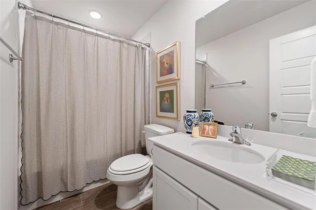 a bedroom with a bed and a flat tv screen on the dresser