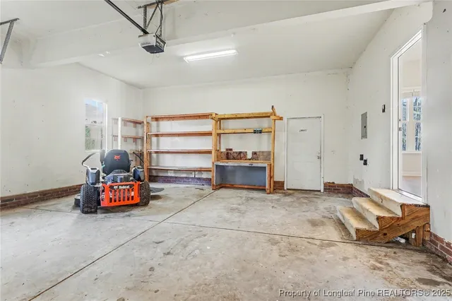 a living room with furniture gym equipment and a chandelier