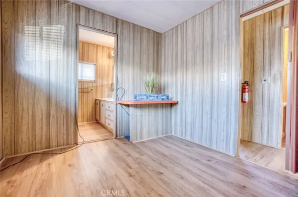 a view of a room with wooden floor and windows