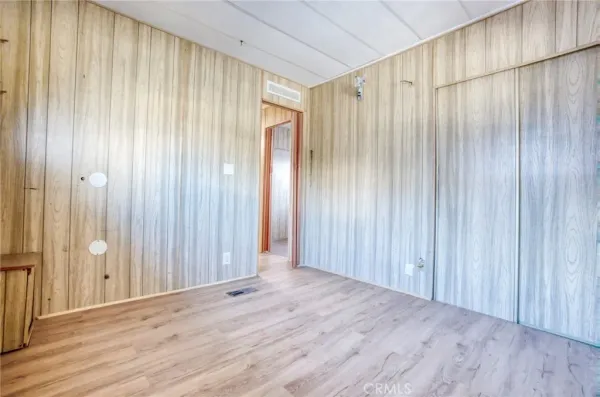 an empty room with wooden floor