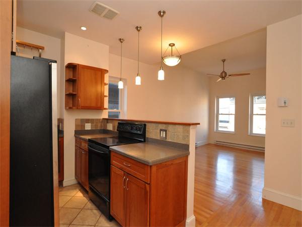 a kitchen that has a sink a stove and a refrigerator