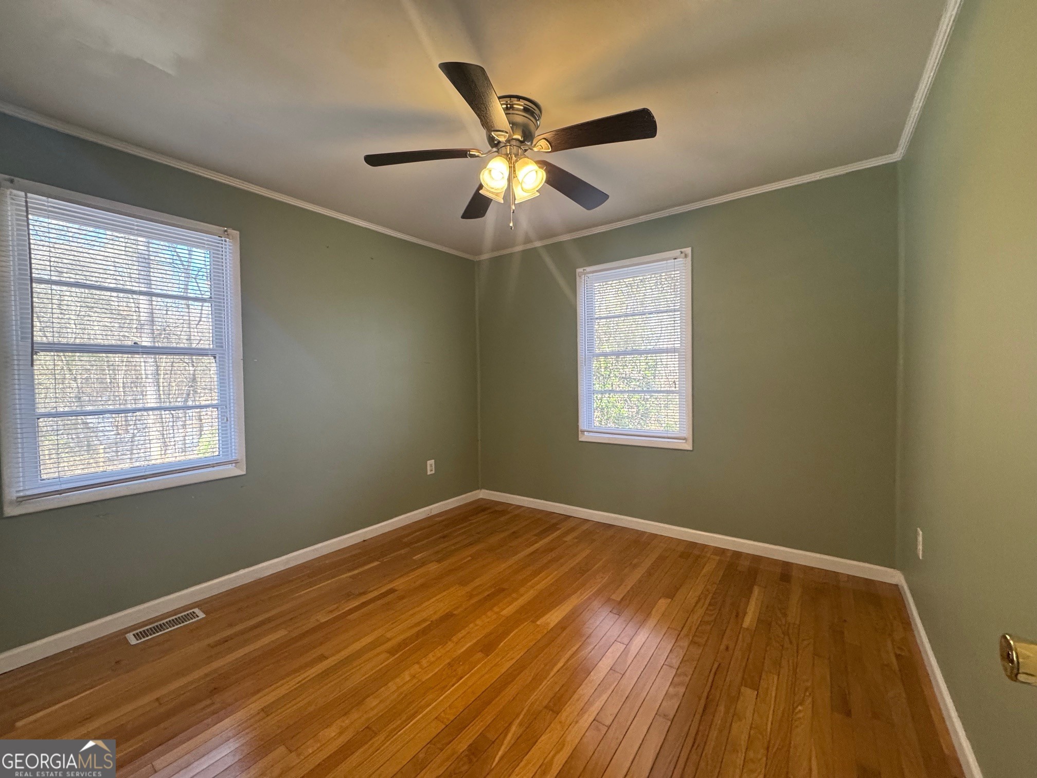 2574 Wire Bridge Road Arnoldsville, GA 30619 - Photo 5 of 10 a view of an empty room with wooden floor and a window