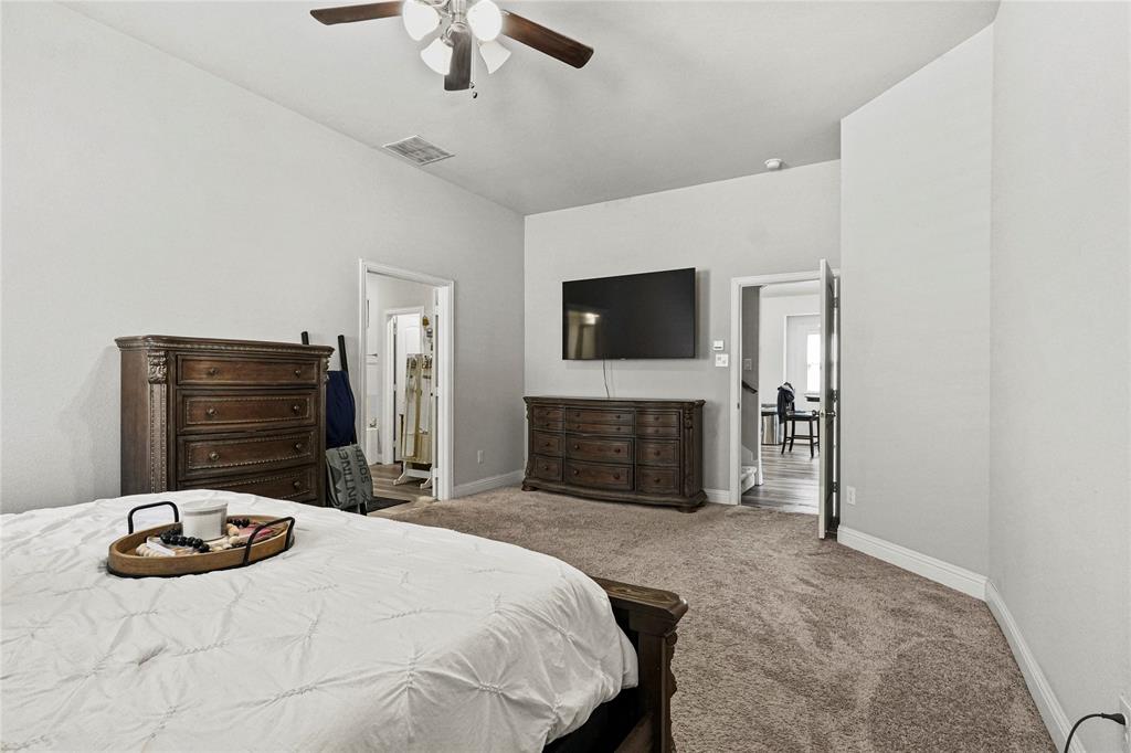 105 Melody Way Red Oak, TX 75154 - Photo 18 of 27 a bedroom with a bed and a television