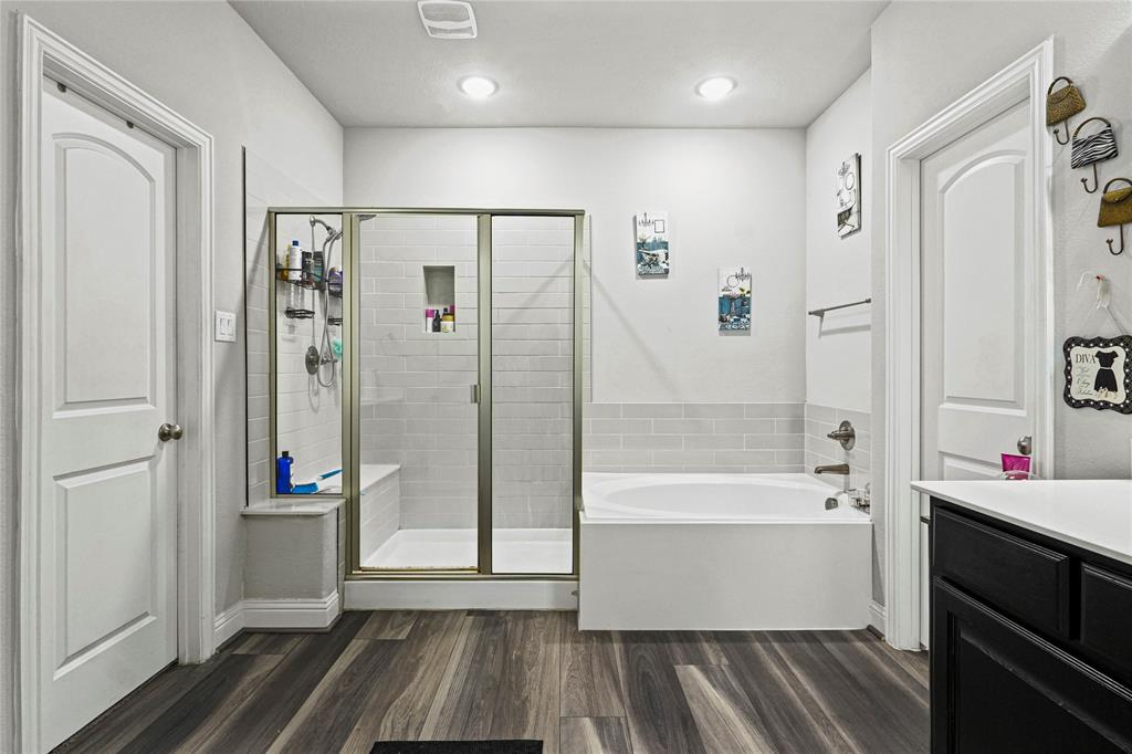 105 Melody Way Red Oak, TX 75154 - Photo 19 of 27 a bathroom with a tub shower vanity and a sink