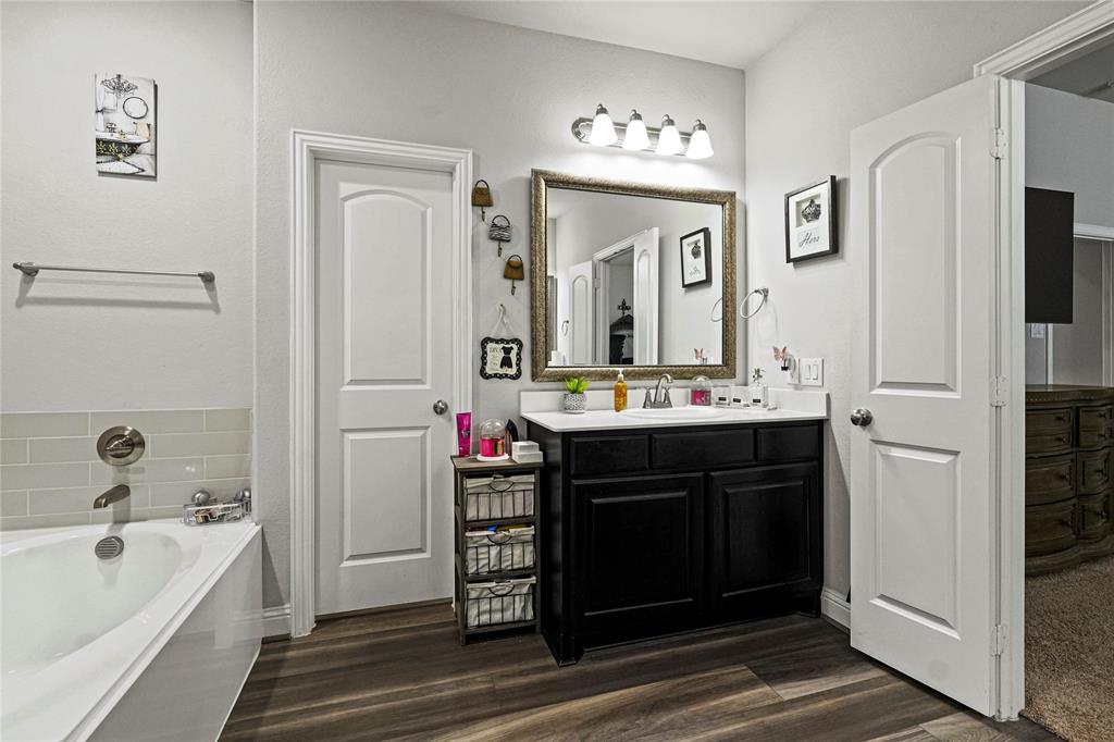 105 Melody Way Red Oak, TX 75154 - Photo 21 of 27 a bathroom with a bathtub sink and mirror
