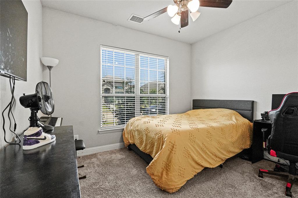 105 Melody Way Red Oak, TX 75154 - Photo 7 of 27 a bedroom with bed and window
