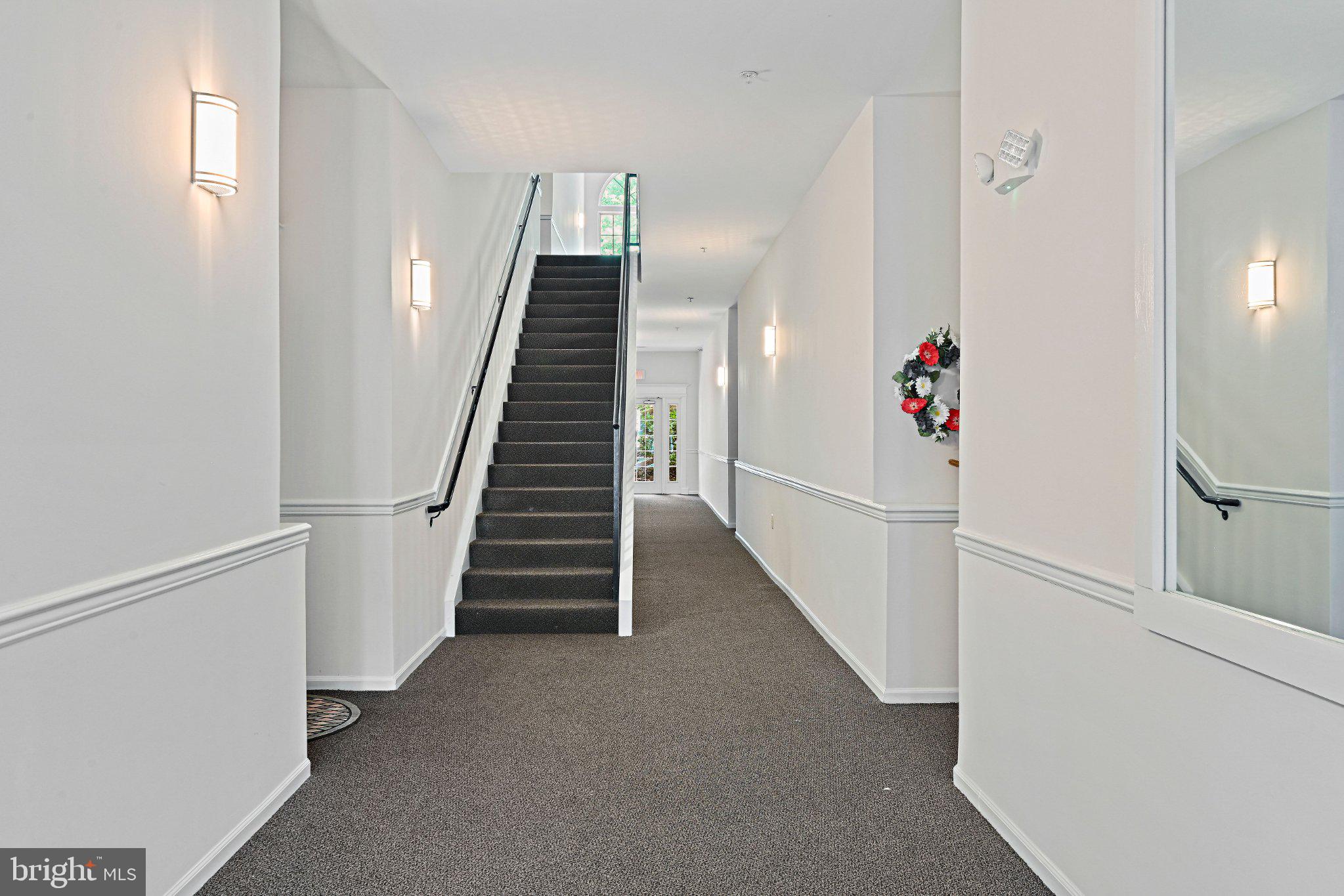1519 North Point Drive, Unit 202 Reston, VA 20194 - Photo 6 of 49 Inviting hallway with elegant staircase.