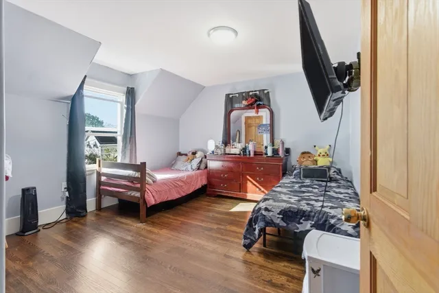 a bedroom with furniture and a wooden floor