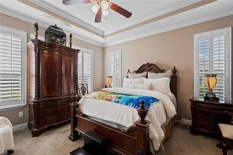 a bedroom with a bed and a ceiling fan