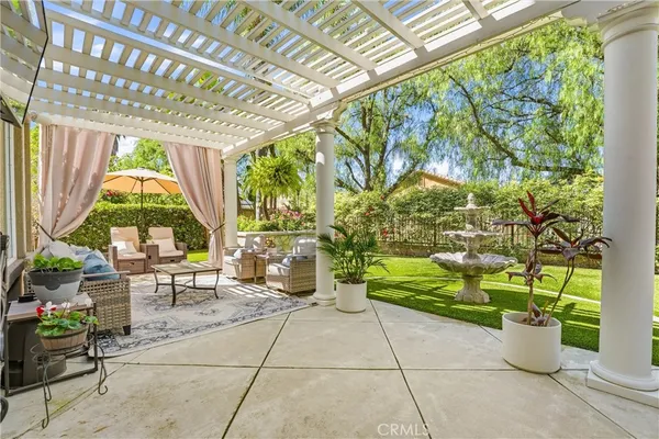 a view of a patio with table and chairs potted plants