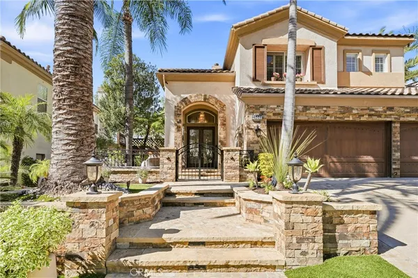 a front view of a house with a garden