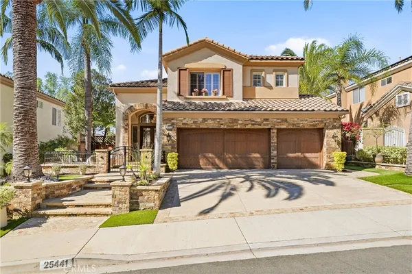 a front view of a house with a yard and a garage