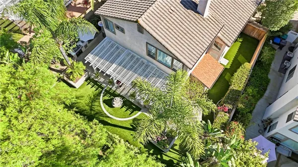 a view of a yard with plants and wooden fence