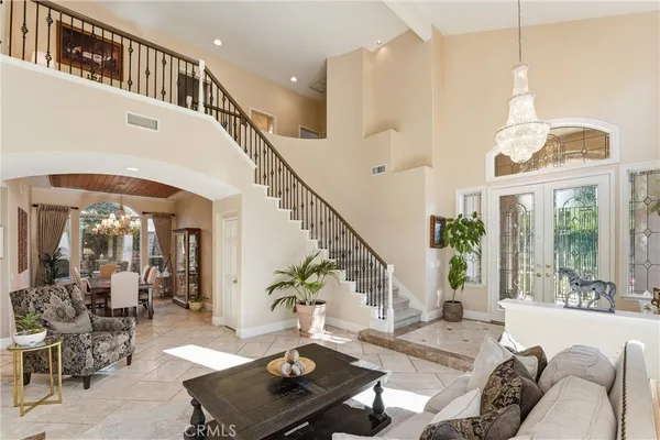 a living room with furniture and a table with wooden floor