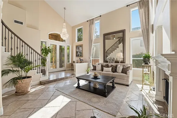 a living room with furniture fireplace and a large window