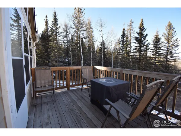 a view of a deck with wooden floor and outdoor seating