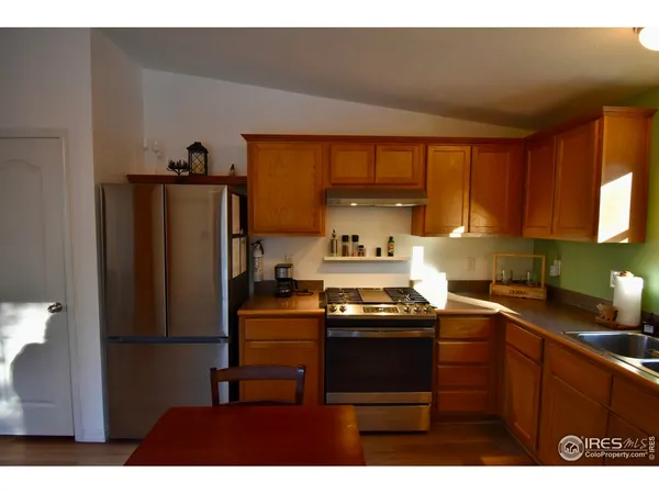 a kitchen with a stove and a refrigerator