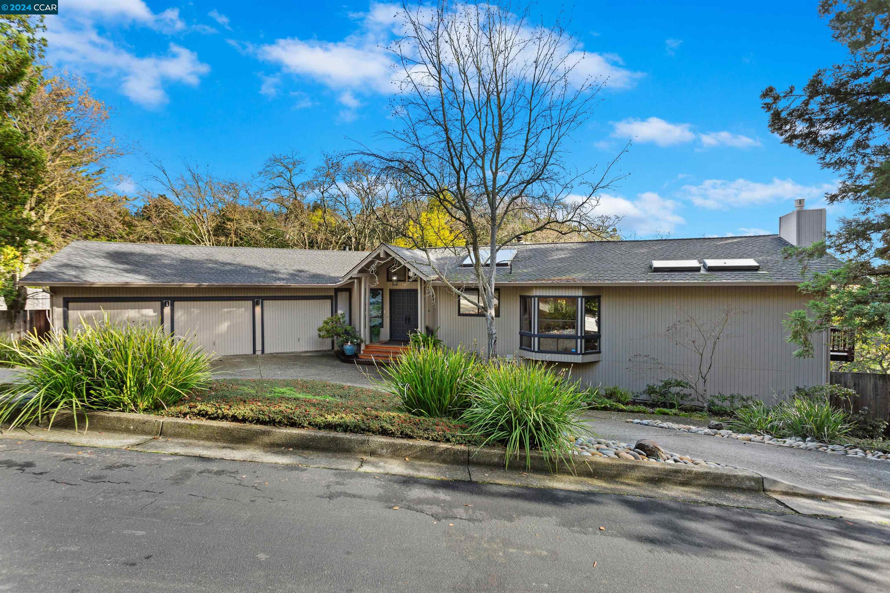 a front view of a house with a garden