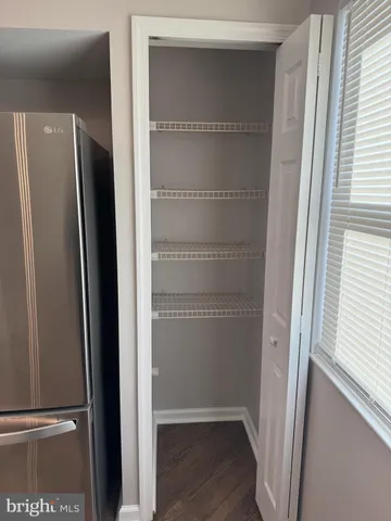 a view of walk in closet with empty racks