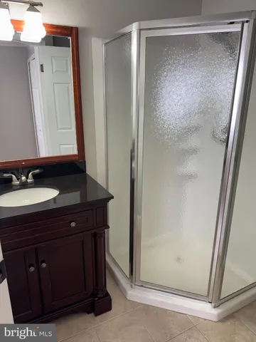 a bathroom with a sink a mirror and a shower