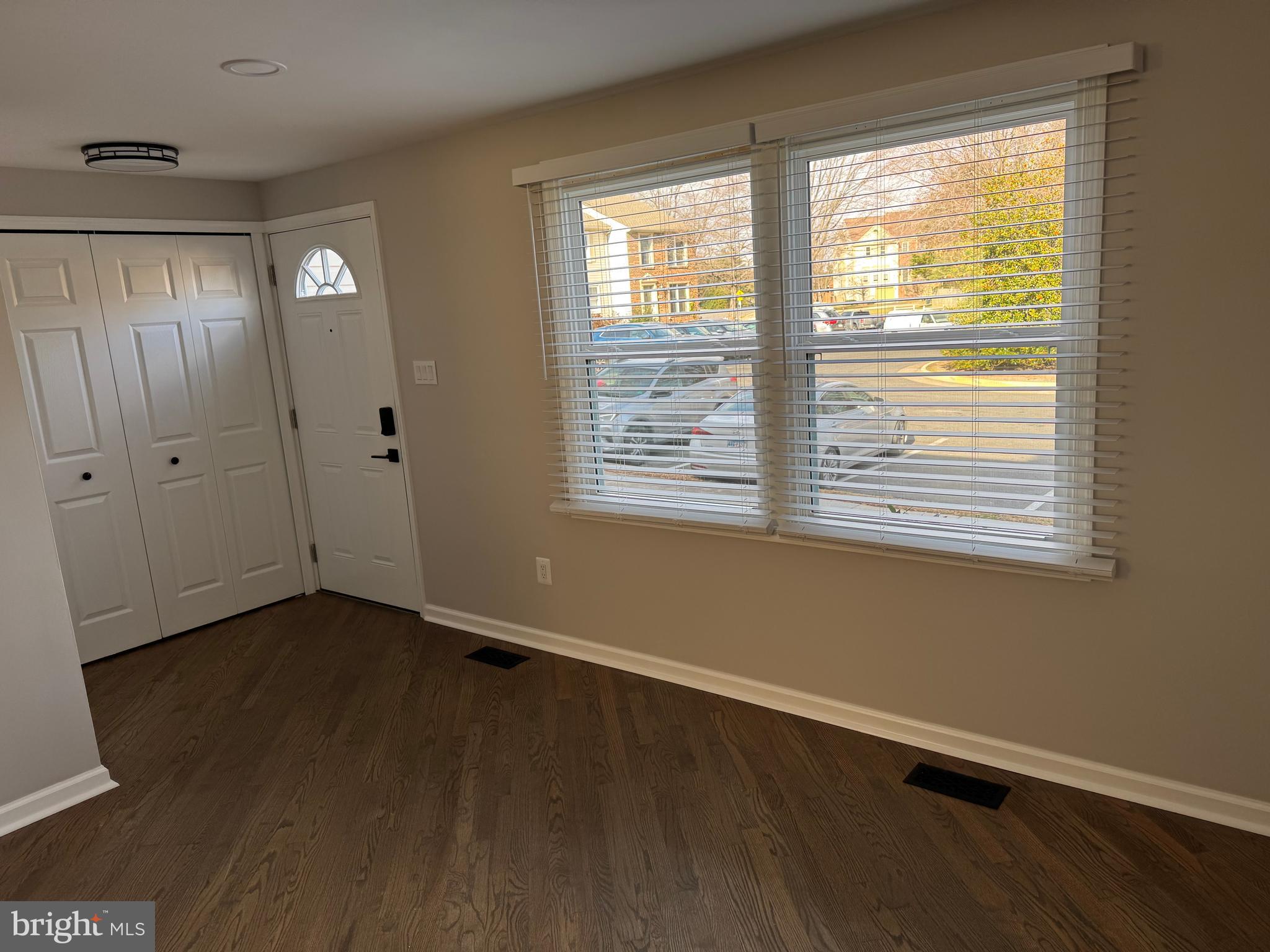 6366 Bonham Place Centreville, VA 20121 - Photo 18 of 18 a view of an empty room with wooden floor and a window