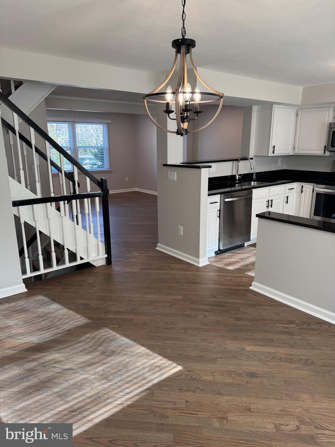 6366 Bonham Place Centreville, VA 20121 - Photo 4 of 18 a view of a kitchen with stainless steel appliances granite countertop a stove and wooden floor