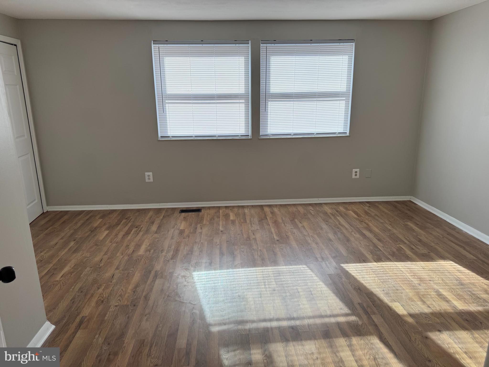 6366 Bonham Place Centreville, VA 20121 - Photo 6 of 18 an empty room with wooden floor and windows
