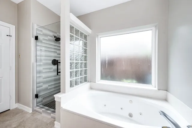 a bathroom with a bathtub and a shower