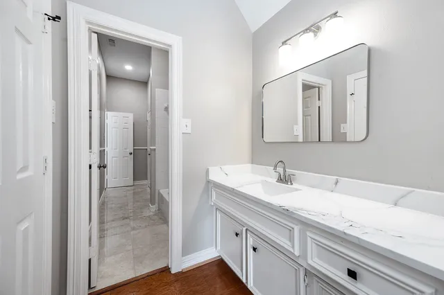 a bathroom with a sink and a mirror