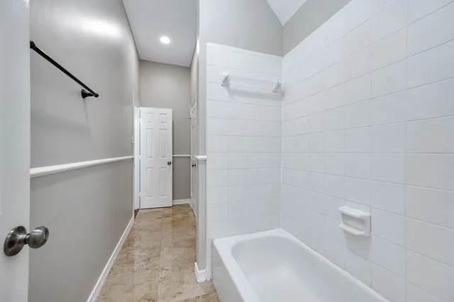 a bathroom with a bathtub and a shower