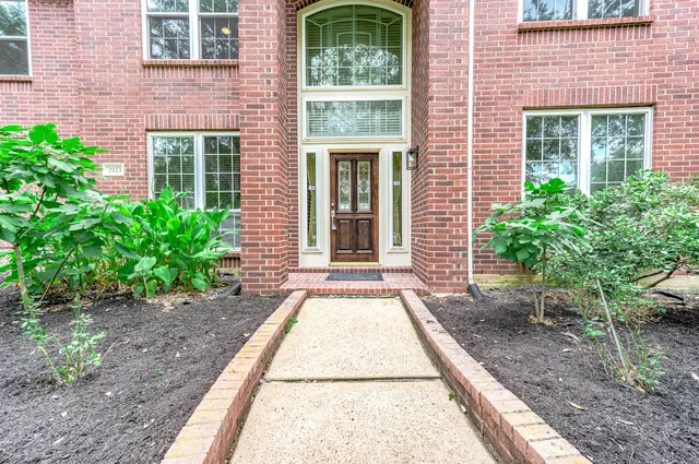 a view of a brick house with yard
