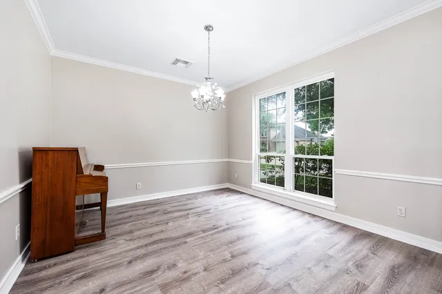 a view of a livingroom with wooden floor and a window