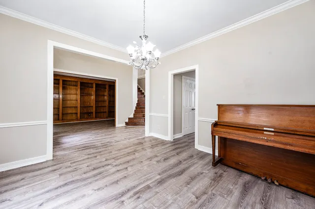 a view of a livingroom with wooden floor and a ceiling fan