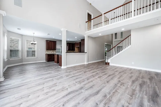 a view of an entryway with wooden floor and a kitchen