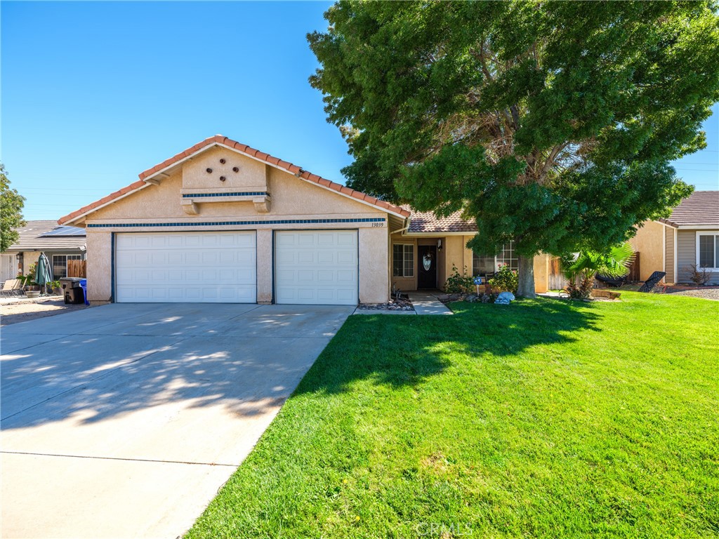 13039 Snowview Road Victorville, CA 92392 - Photo 1 of 1 a front view of a house with garden