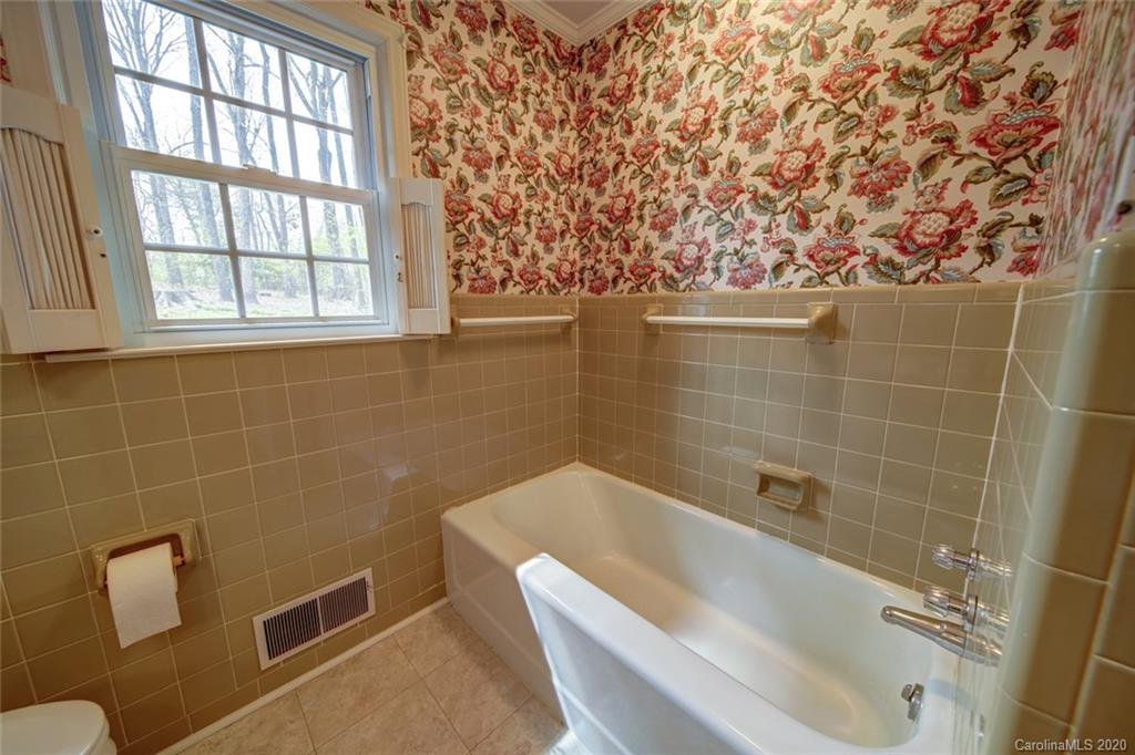 1415 Melchor Road Albemarle, NC 28001 - Photo 23 of 47 a bath tub sitting in a bathroom next to a window