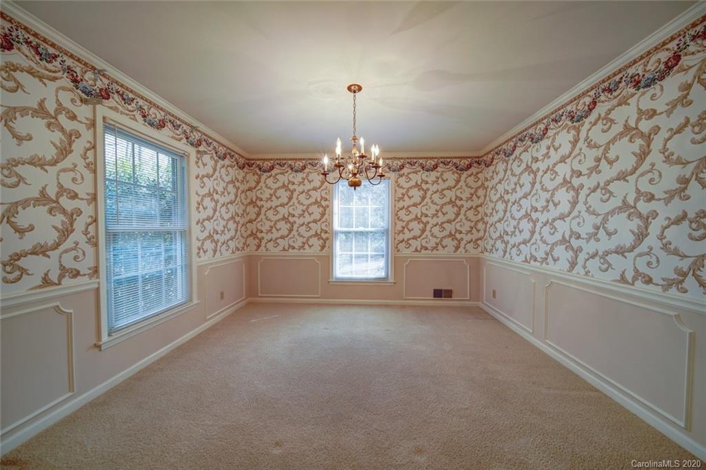 1415 Melchor Road Albemarle, NC 28001 - Photo 25 of 47 en empty room with windows and chandelier