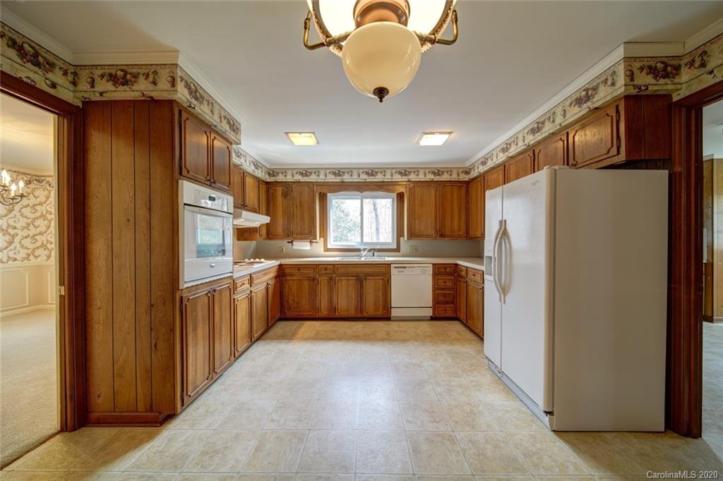1415 Melchor Road Albemarle, NC 28001 - Photo 30 of 47 a kitchen with stainless steel appliances a refrigerator and a stove